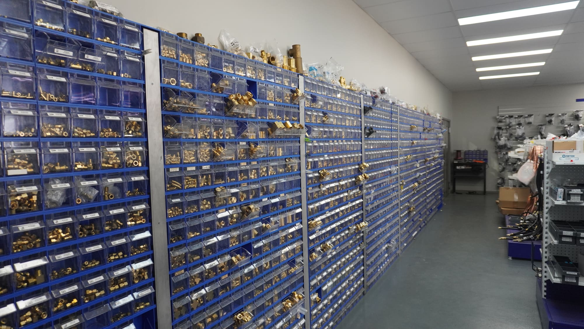 Wall of hydraulic hose fittings and adaptors at Pirtek Townsville