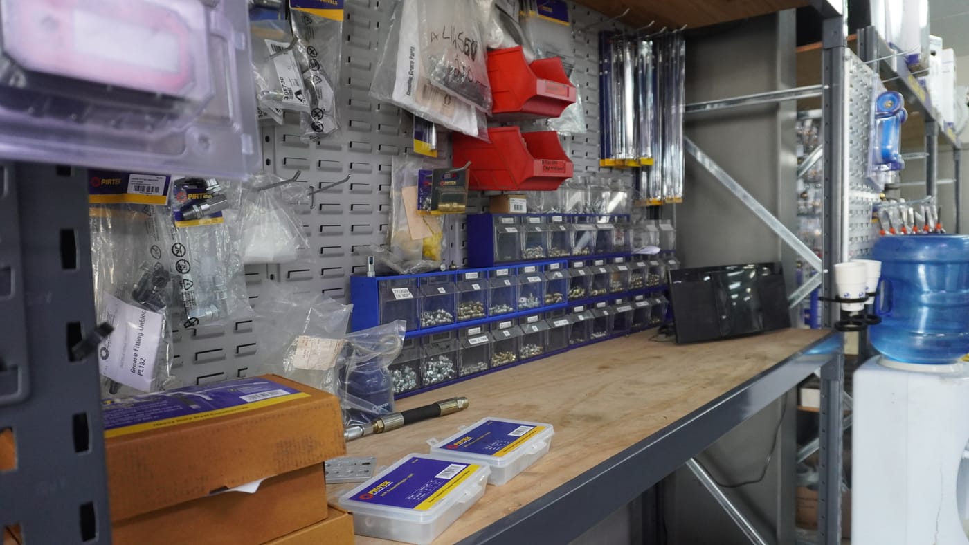 Bins of brass and metal hydraulic fittings at Pirtek Townsville — Caterpillar, metric and more