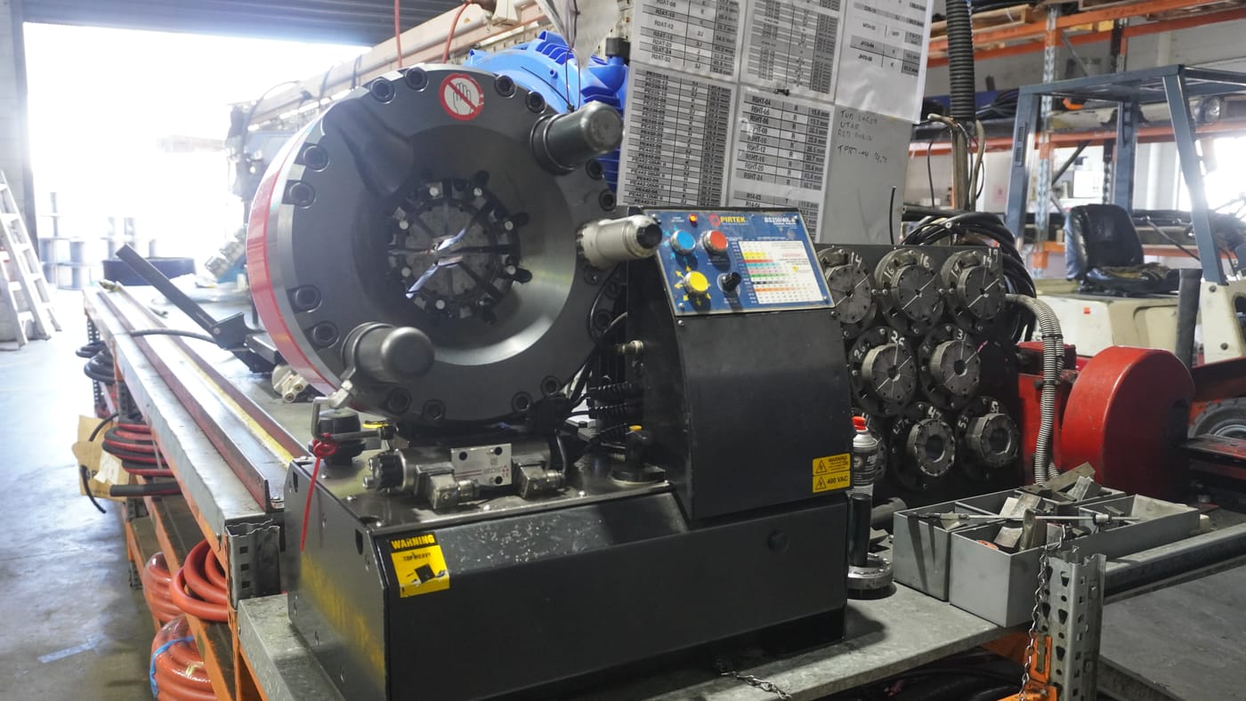 A hydraulic hose being crimped to specification on a Pirtek crimping machine at Pirtek Townsville