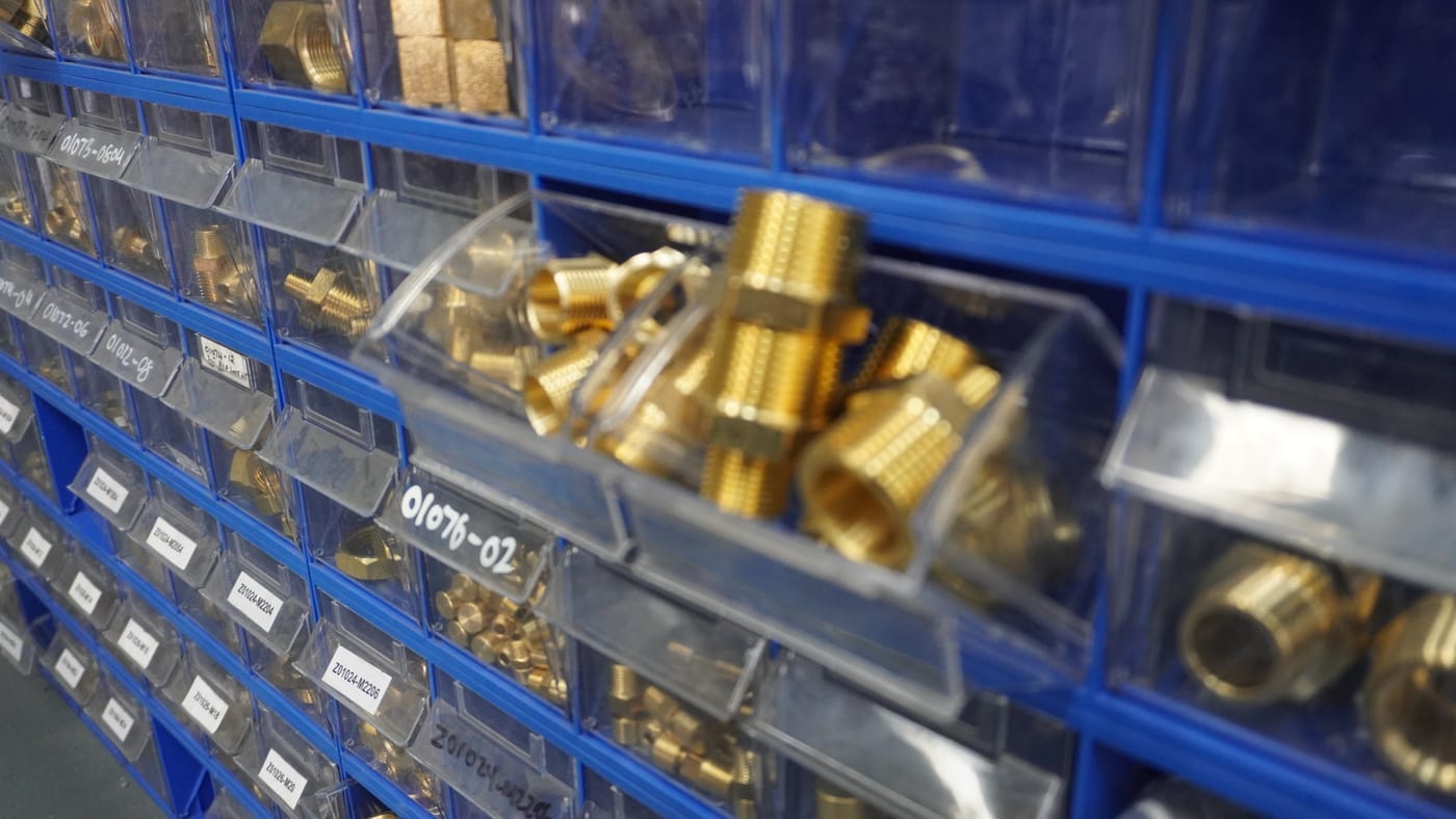 Close-up of brass hydraulic hose fittings in stock at Pirtek Townsville