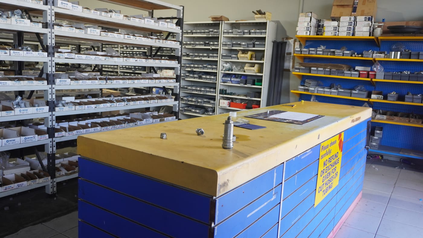 The parts counter at Pirtek Townsville, stocked with hoses, fittings and pressure washer parts